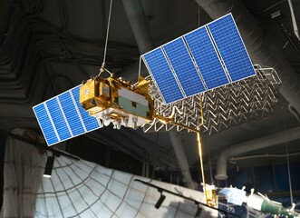 A model of a space satellite with solar panels and parts demonstrated in a planetarium