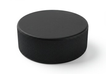 A single black hockey puck isolated on a white background in a studio shot with soft shadows around it
