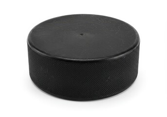 A studio shot of a single black hockey puck isolated on a white background with soft shadow detail