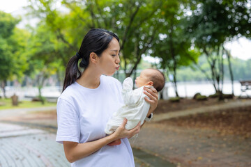 Fototapeta premium Mother spending time with newborn baby at park