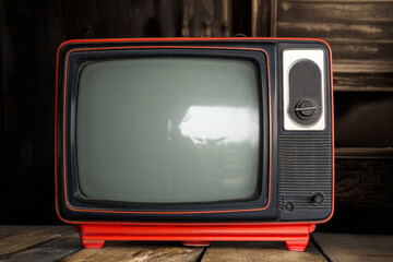 Vintage television stands against a wooden backdrop in a cozy room filled with nostalgia