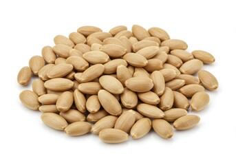 A heap of blanched almonds scattered on a plain white surface in a close up studio shot view