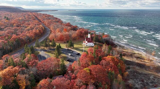 Aerial drone view of Point Iroquois Lighthouse surrounded by vibrant fall colors along Lake Superior&rsquo;s rugged coastline in Michigan&rsquo;s Upper Peninsula