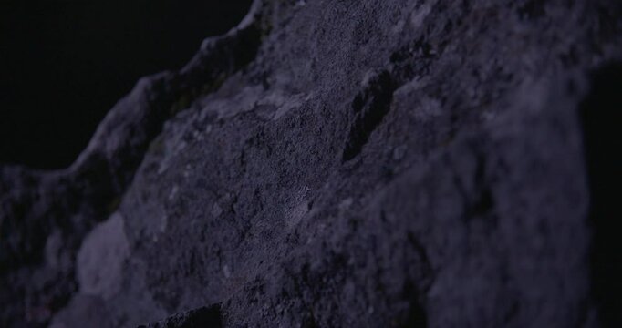 Close-up of weathered stone at Drombeg, handheld and lit by shifting light, capturing the texture and mystery of this ancient site.