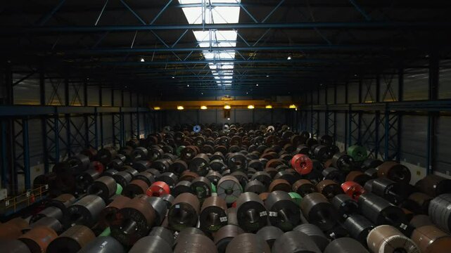 Beautiful aerial view of large steel coils in a dark warehouse