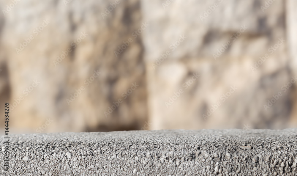 Fototapete Empty table copy space. Stone countertop table stage podium display with blurred bokeh background and soft sunlight. Empty concrete stone podium platform
