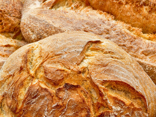 Freshly baked artisanal bread offers a warm embrace in a rustic bakery during the golden hour of...