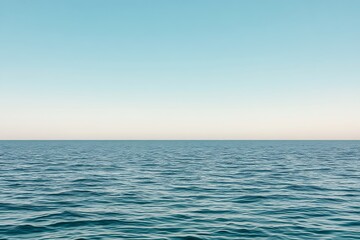 Obraz premium Serene seascape of calm teal ocean with cloudless, pale blue sky horizon