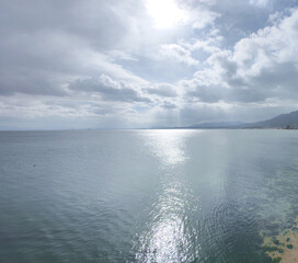 clouds over the lake biwa clear water sun reflection in sunny day