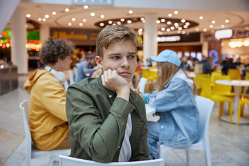 Portrait of upset teenage boy suffering from bullying of friends