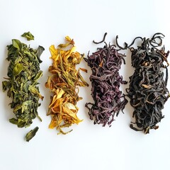 An array of diverse tea leaves, varying in shades of green, yellow, purple, and dark brown, presented on a plain background.
