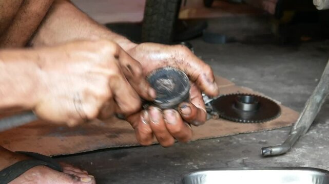 A motorcycle mechanic performs repairs and maintenance, cleaning on motorcycle pistons