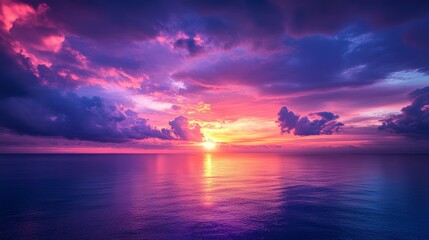 Vibrant sunset over calm ocean, colorful clouds reflecting on water.