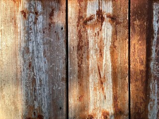 Fototapeta premium old gray boards with torn off remains of burgundy paint background for your design