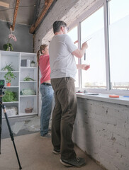 a couple toning windows glass at home using toning film