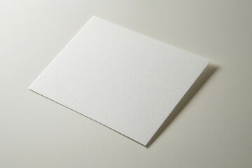 Blank textured paper lying on a clean surface, ideal for creative projects and presentations