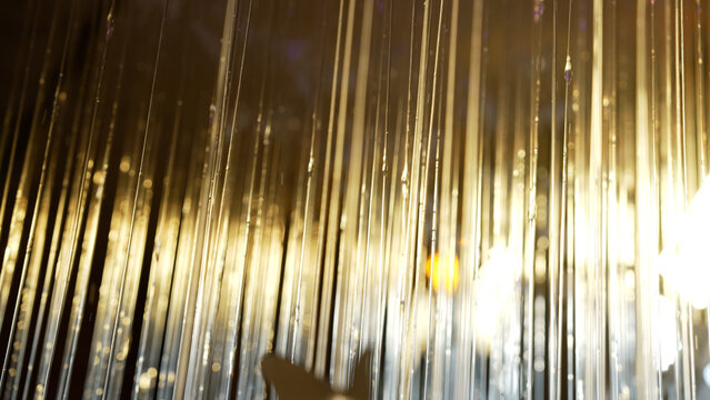 Golden light beams cascading and forming an abstract background, enhanced by a dreamy bokeh effect, creating a warm and elegant atmosphere