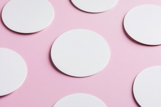 Circular coasters arranged on a pink background, ideal for home decor and events