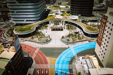 Top-Down Aerial of Kaohsiung New Station Plaza: Unique Design, Colorful Traffic, and Busy Urban Hub...
