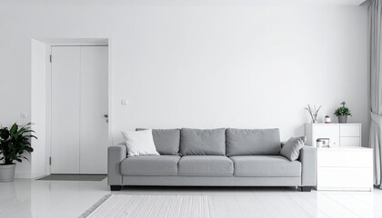 A cozy living room featuring bright white walls and sleek white flooring, adorned with a plush gray sofa, colorful throw pillows, and a stylish coffee table.