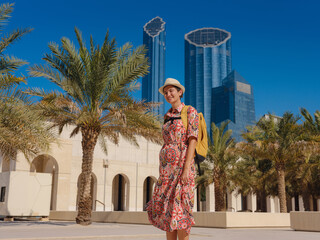 Young woman exploring Qasr Al Hosn Park in Abu Dhabi. Surrounded by lush greenery and historical landmarks, she enjoys the serene atmosphere and Emirati heritage in heart of city.