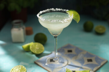 A glass with margarita cocktail with lime	