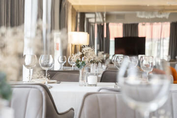 beautiful table decoration in restaurant. festive table setting in restaurant. white tablecloth on...