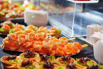 Delicious shrimp skewers served with fresh vegetables at a buffet event