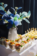 Delicious dessert cups and floral arrangement at a festive event