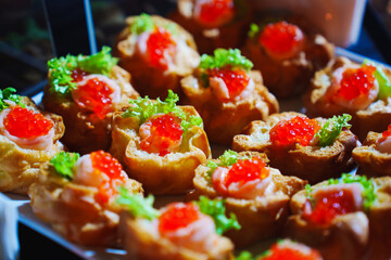 Gourmet appetizers with caviar and lettuce served at a lavish banquet
