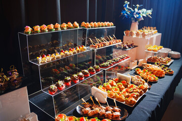 Elegant buffet display of assorted appetizers and desserts at a formal event