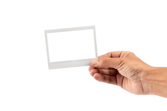 Male hand holding an instant picture photograph frame isolated no background