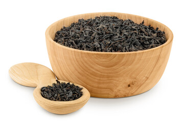 Dry black tea leaves in wooden bowl and spoon isolated on white background