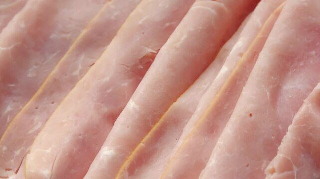 Thin boiled packed ham slices extreme close up rotating very slowly stock footage