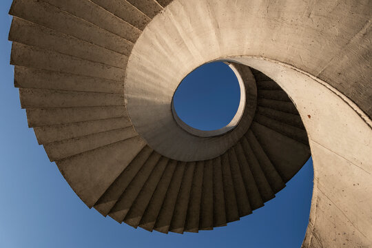 Abstract view of a circular concrete stairway under the Gdanski Bridge in Warsaw, Poland