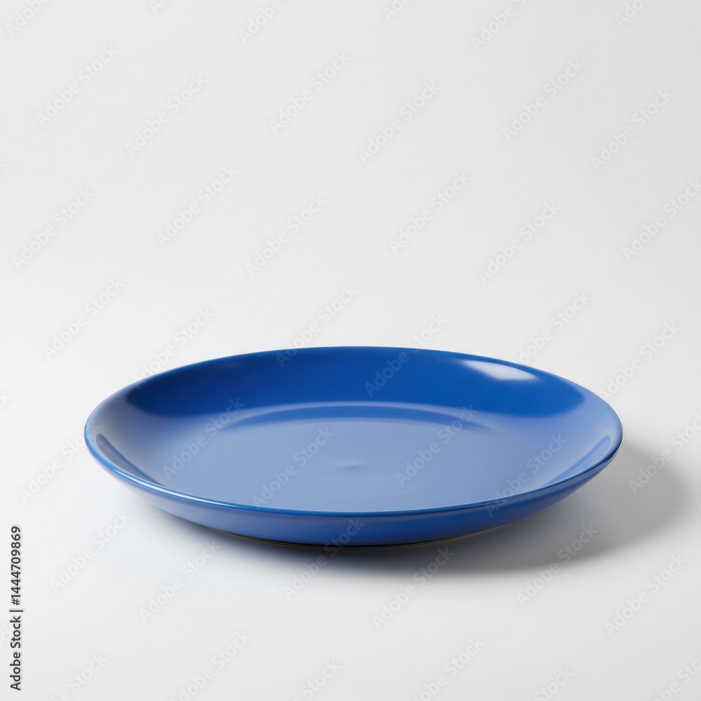 Poster a simple image showing a single blue plate centered on a plain white background in a studio shot