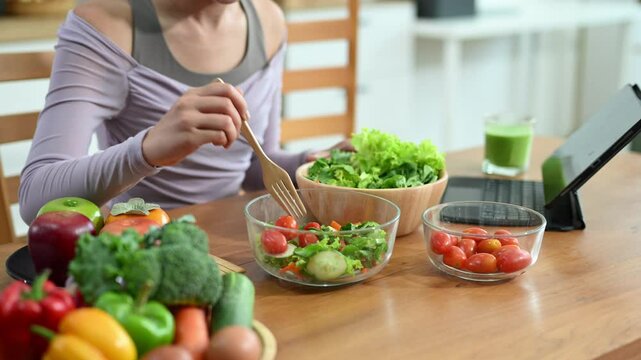Closeup  female in kitchen and writing down healthy recipe or daily ration diet at home. Active healthy lifestyle