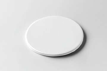 Minimalist white ceramic plate on a smooth surface, ideal for food presentation
