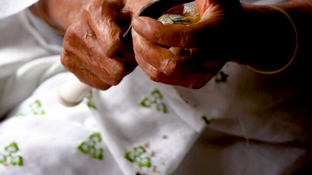 Old woman cutting Betel Nut by hand in Assam 1
