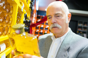 customer holding a bottle of yellow liquor