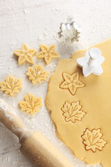 raw cookie dough pressed with cookie cutter