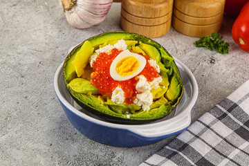 Avocado with red caviar and quil egg
