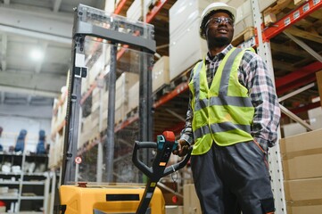 african american Storehouse manager supervising the lift truck operator