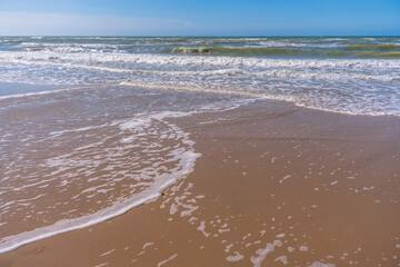 Stunning view of the North Sea from a sandy summer beach in Hirtshals, Denmark. Peaceful waves and wide horizons define this coastal scene