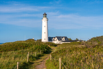 The old Hirtshals Fyr lighthouse marks the Danish coast with its white tower, offering wide views...