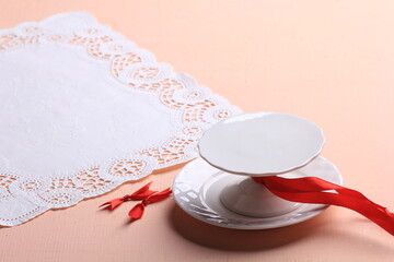 empty cake stand and lace mat on pink background
