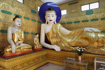 Large Reclining Buddha Statue Surrounded by Gold Leaf Decor