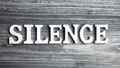 Fototapeta premium Silence Word on Gray Wooden Background: Calm, Peaceful Stock Photo