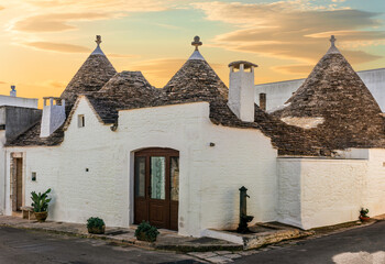 beautiful touristic view of white mediterranean buildings in old medieval Italian style of trulli...