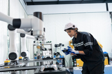 Robotics manufacturing industry. Engineer control and training autonomous robot. Test programmable logic controller with AI robot training kit and mechatronics engineering